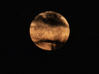 The Full Moon of July 2024 known as Buck Moon or Thunder Moon spotted behind clouds over Mount Olympus in Greece. Mount Olympus is a Nationa...