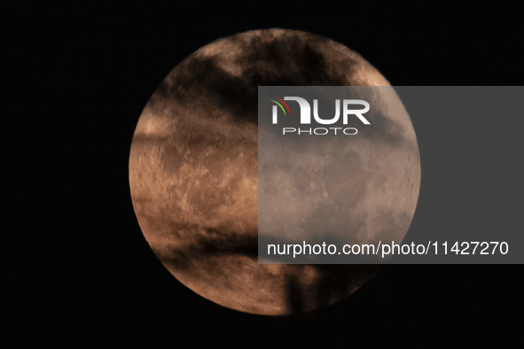 The Full Moon of July 2024 known as Buck Moon or Thunder Moon spotted behind clouds over Mount Olympus in Greece. Mount Olympus is a Nationa...