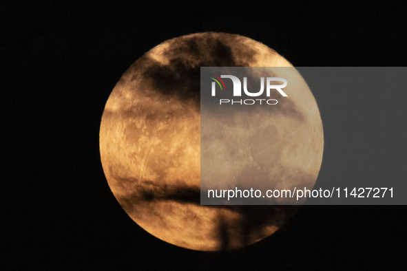 The Full Moon of July 2024 known as Buck Moon or Thunder Moon spotted behind clouds over Mount Olympus in Greece. Mount Olympus is a Nationa...