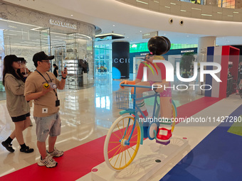 A shopping mall is turning its atrium into a cartoon arena to host a series of events for the upcoming Paris Olympic Games in Shanghai, Chin...