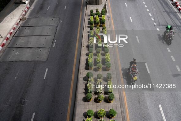 Motorcycles are driving on Sukhumvit Road in Bangkok, Thailand, on July 22, 2024 