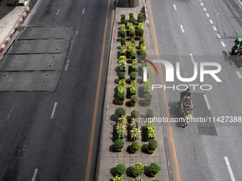 Motorcycles are driving on Sukhumvit Road in Bangkok, Thailand, on July 22, 2024 (