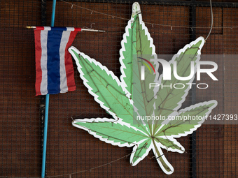 A large marijuana leaf is being displayed on the outside of a neighborhood cannabis dispensary in Bangkok, Thailand, on July 22, 2024 (