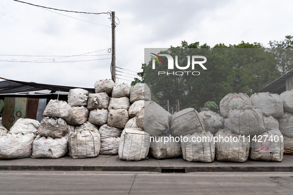 Large bags of waste are sitting outside of a sorting facility in Bangkok, Thailand, on July 22, 2024 