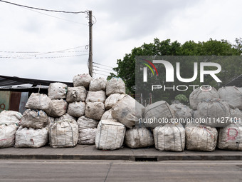 Large bags of waste are sitting outside of a sorting facility in Bangkok, Thailand, on July 22, 2024 (