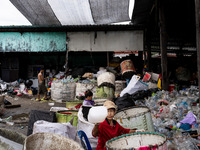 Burmese workers are sorting rotting food waste, fabric, and recyclable plastic by hand at a sorting facility in Bangkok, Thailand, on July 2...