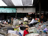 Burmese workers are sorting rotting food waste, fabric, and recyclable plastic by hand at a sorting facility in Bangkok, Thailand, on July 2...