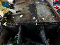 Burmese workers are sorting rotting food waste, fabric, and recyclable plastic by hand at a sorting facility in Bangkok, Thailand, on July 2...