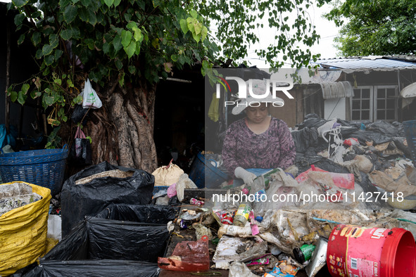 Burmese workers are sorting rotting food waste, fabric, and recyclable plastic by hand at a sorting facility in Bangkok, Thailand, on July 2...