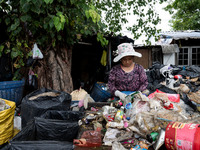 Burmese workers are sorting rotting food waste, fabric, and recyclable plastic by hand at a sorting facility in Bangkok, Thailand, on July 2...