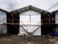 Corrugated steel housing units are accommodating Burmese workers who are sorting rotting food waste, fabric, and recyclable plastic by hand...