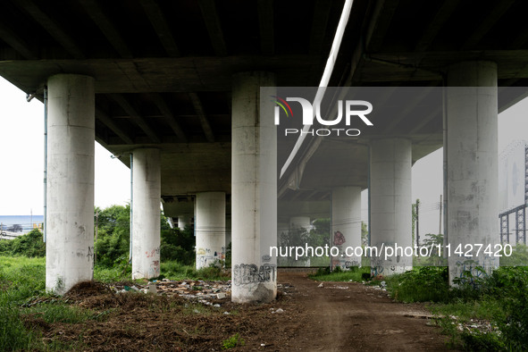 A general view is showing a waste dumping and burning ground beneath a highway in Bangkok, Thailand, on July 22, 2024 