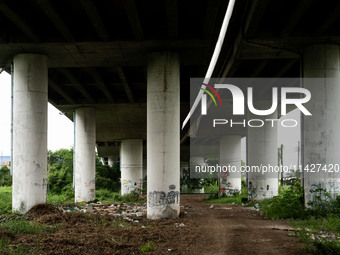 A general view is showing a waste dumping and burning ground beneath a highway in Bangkok, Thailand, on July 22, 2024 (