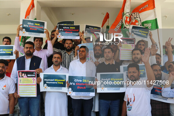 Members of the youth wing of the Indian National Congress party are shouting slogans and holding placards during a protest in Srinagar, Jamm...