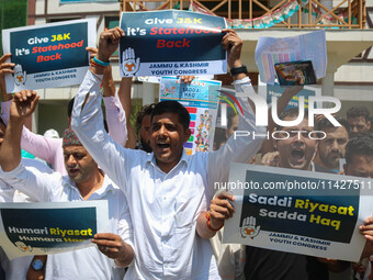 Members of the youth wing of the Indian National Congress party are shouting slogans and holding placards during a protest in Srinagar, Jamm...