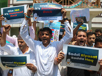 Members of the youth wing of the Indian National Congress party are shouting slogans and holding placards during a protest in Srinagar, Jamm...