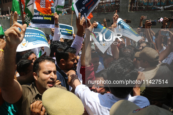 Members of the youth wing of the Indian National Congress party are shouting slogans as Indian police officers are trying to stop them durin...