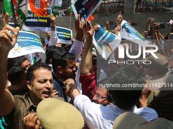 Members of the youth wing of the Indian National Congress party are shouting slogans as Indian police officers are trying to stop them durin...