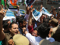 Members of the youth wing of the Indian National Congress party are shouting slogans as Indian police officers are trying to stop them durin...