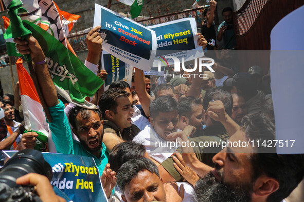 Members of the youth wing of the Indian National Congress party are shouting slogans as Indian police officers are trying to stop them durin...