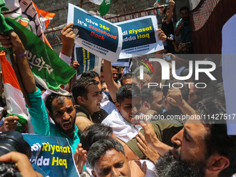 Members of the youth wing of the Indian National Congress party are shouting slogans as Indian police officers are trying to stop them durin...