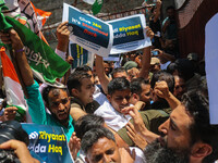 Members of the youth wing of the Indian National Congress party are shouting slogans as Indian police officers are trying to stop them durin...