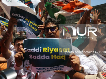 Members of the youth wing of the Indian National Congress party are shouting slogans and holding placards during a protest in Srinagar, Jamm...