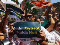 Members of the youth wing of the Indian National Congress party are shouting slogans and holding placards during a protest in Srinagar, Jamm...