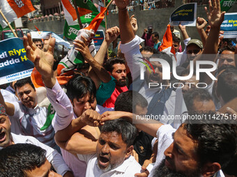 Members of the youth wing of the Indian National Congress party are shouting slogans and holding placards during a protest in Srinagar, Jamm...