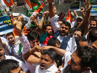 Members of the youth wing of the Indian National Congress party are shouting slogans and holding placards during a protest in Srinagar, Jamm...