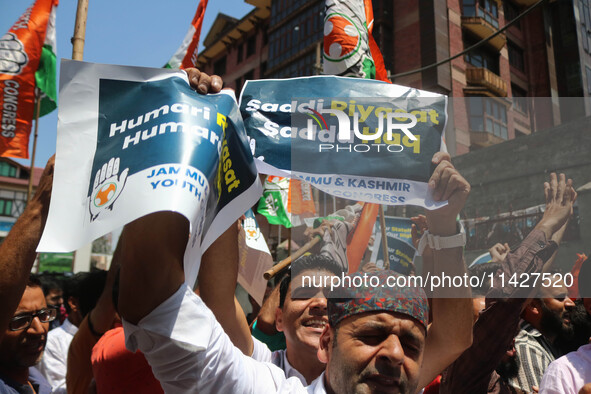 Members of the youth wing of the Indian National Congress party are shouting slogans and holding placards during a protest in Srinagar, Jamm...