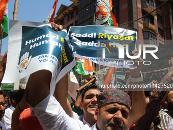 Members of the youth wing of the Indian National Congress party are shouting slogans and holding placards during a protest in Srinagar, Jamm...