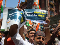 Members of the youth wing of the Indian National Congress party are shouting slogans and holding placards during a protest in Srinagar, Jamm...