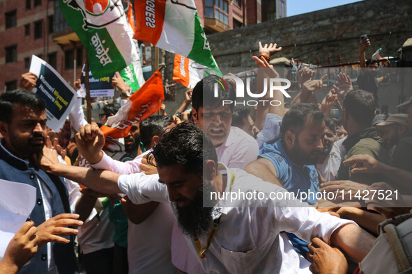 Members of the youth wing of the Indian National Congress party are shouting slogans as Indian police officers are trying to stop them durin...