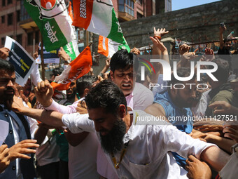 Members of the youth wing of the Indian National Congress party are shouting slogans as Indian police officers are trying to stop them durin...