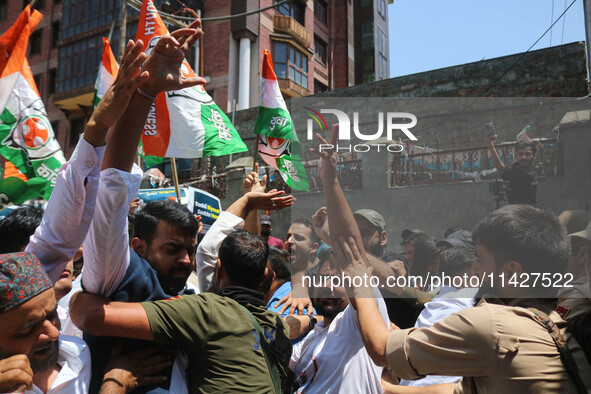 Members of the youth wing of the Indian National Congress party are shouting slogans as Indian police officers are trying to stop them durin...