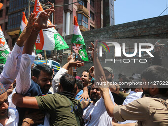 Members of the youth wing of the Indian National Congress party are shouting slogans as Indian police officers are trying to stop them durin...