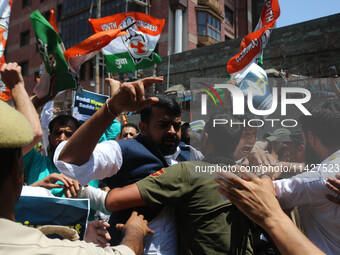 Members of the youth wing of the Indian National Congress party are shouting slogans as Indian police officers are trying to stop them durin...