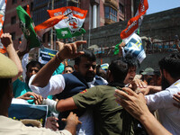 Members of the youth wing of the Indian National Congress party are shouting slogans as Indian police officers are trying to stop them durin...