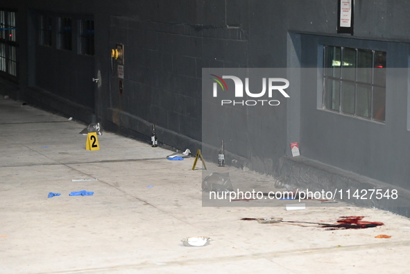 Evidence markers are being placed at the crime scene where shell casings and blood are being discovered. Police are investigating the crime...