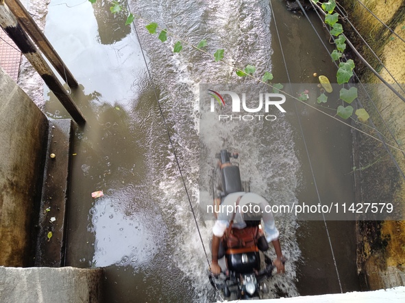 Commuters are wading through a waterlogged subway during the monsoon rain in Kolkata, India, on July 22, 2024. 