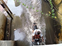 Commuters are wading through a waterlogged subway during the monsoon rain in Kolkata, India, on July 22, 2024. (