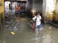 Commuters are wading through a waterlogged subway during the monsoon rain in Kolkata, India, on July 22, 2024. (