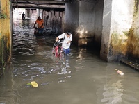 Commuters are wading through a waterlogged subway during the monsoon rain in Kolkata, India, on July 22, 2024. (