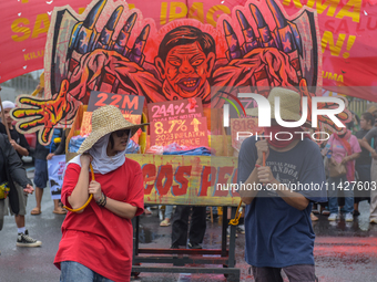 Demonstrators are carrying banners and placards and are gathering in the streets of Quezon City, Philippines, on July 22, 2024. Protestors a...