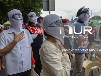 Demonstrators are carrying banners and placards and are gathering in the streets of Quezon City, Philippines, on July 22, 2024. Protestors a...