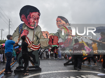 Demonstrators are carrying banners and placards and are gathering in the streets of Quezon City, Philippines, on July 22, 2024. Protestors a...