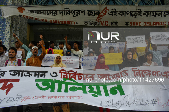 Students from Aliah University are holding posters as they are taking part in a demonstration in Kolkata, India, on July 22, 2024, demanding...