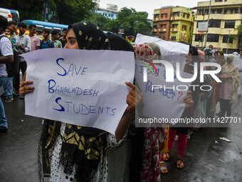 Students from Aliah University are holding posters as they are taking part in a demonstration in Kolkata, India, on July 22, 2024, demanding...