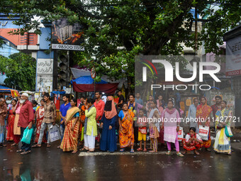 A crowd of people is waiting for transport in Kolkata, India, on July 22, 2024. (